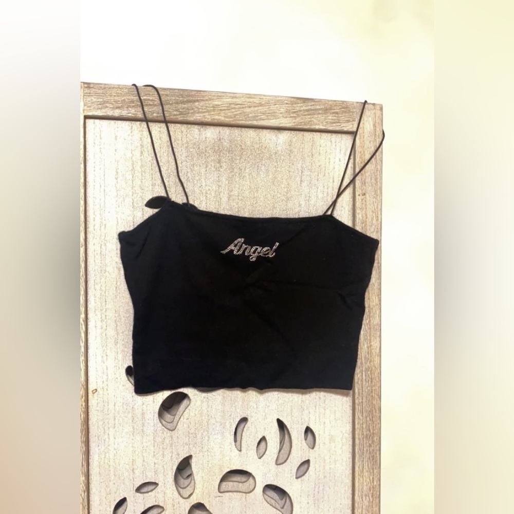 This is a black crop top with text that says, Angel.
